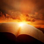 Open Bible, light from sun