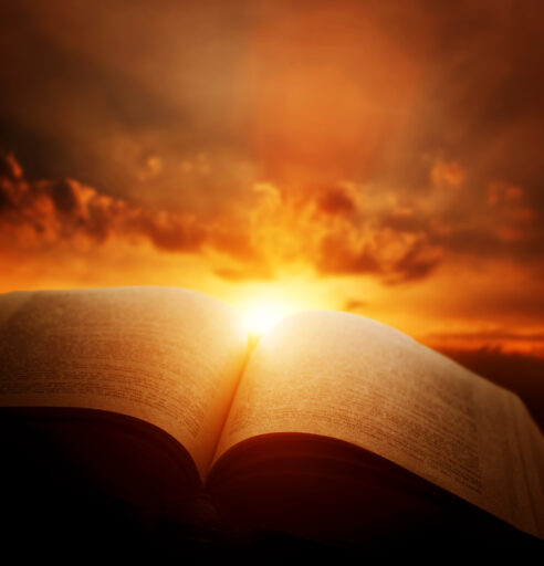 Open Bible, light from sun